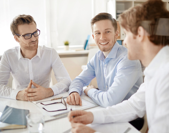 Group of businessmen discussing plans in office