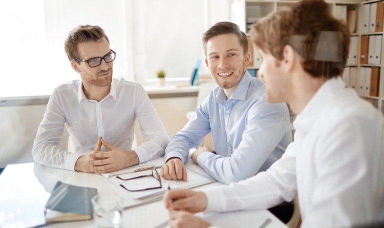 Group of businessmen discussing plans in office